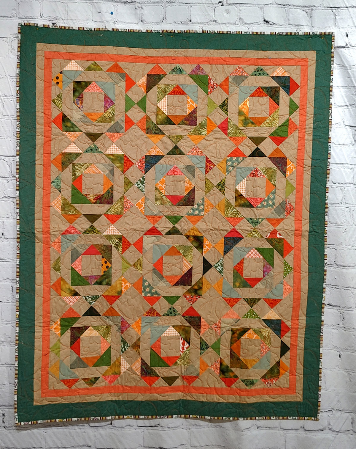 Fall colored scrappy green, brown, orange baby lap quilt