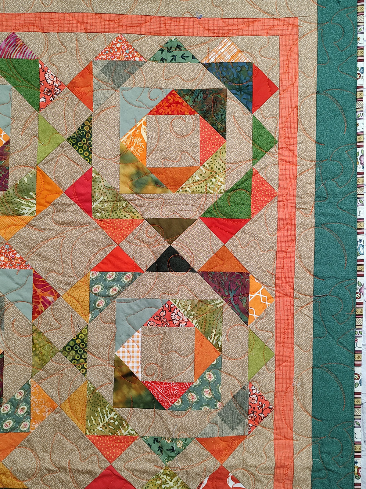 Fall colored scrappy green, brown, orange baby lap quilt