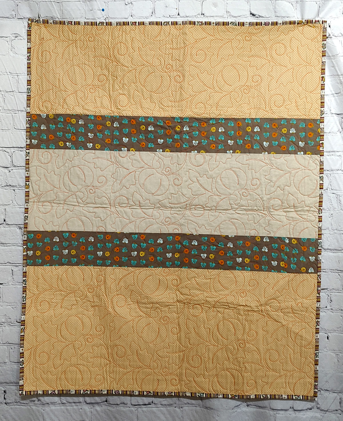 Fall colored scrappy green, brown, orange baby lap quilt