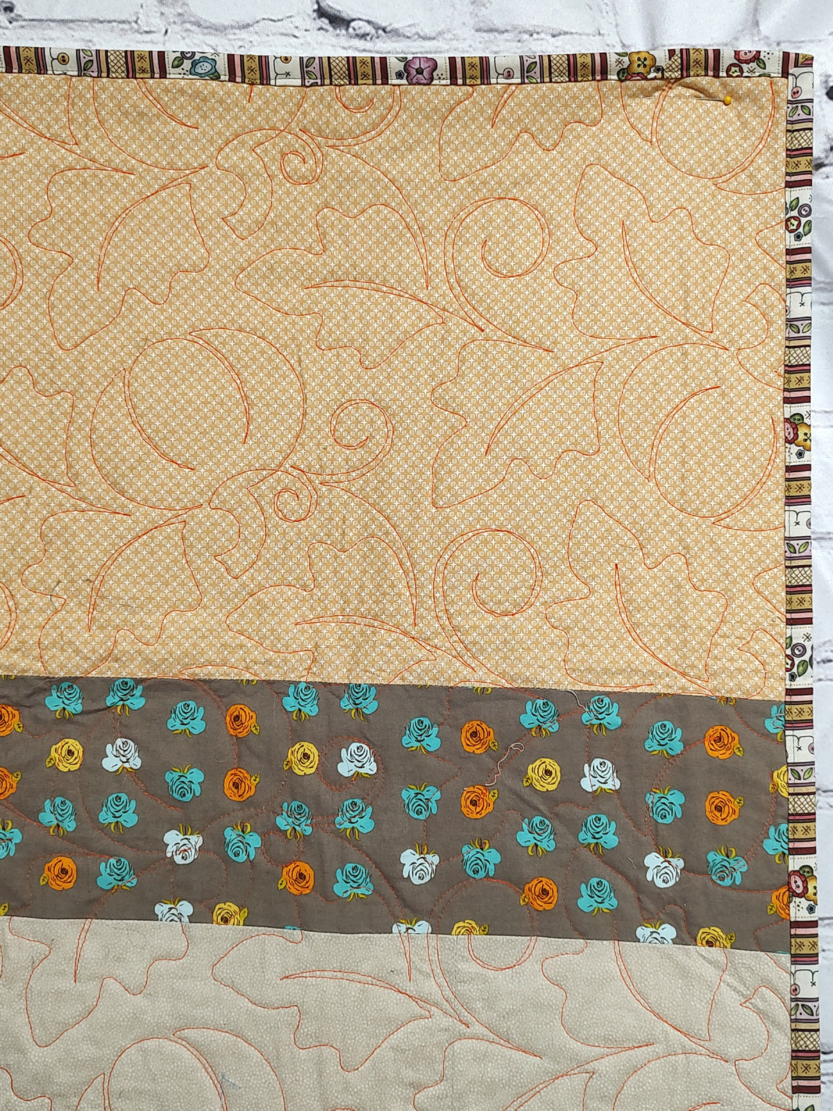 Fall colored scrappy green, brown, orange baby lap quilt