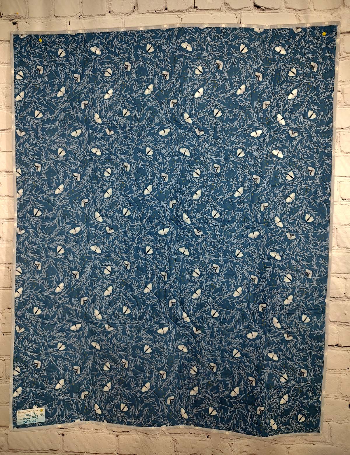 Blue and grey Modern Moth Fragility baby lap quilt