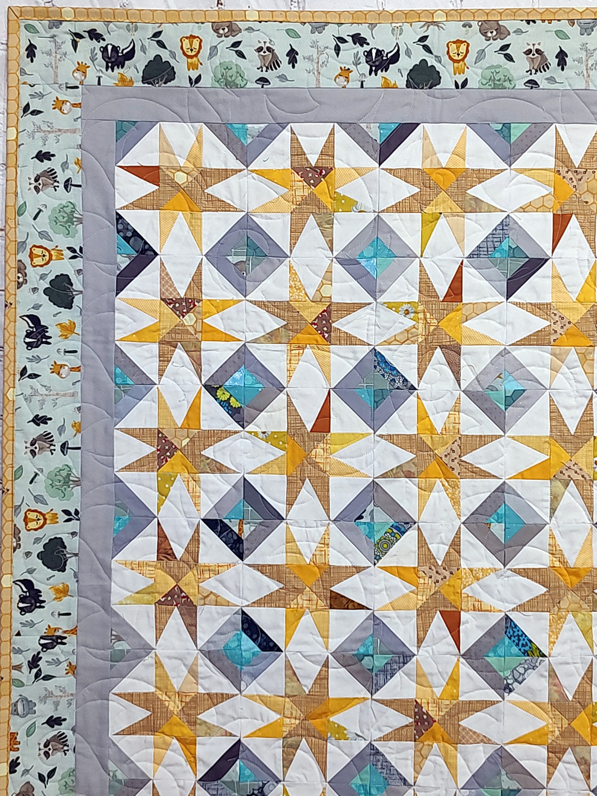 Super Nova scrappy jungle yellow and turquoise Baby Lap quilt