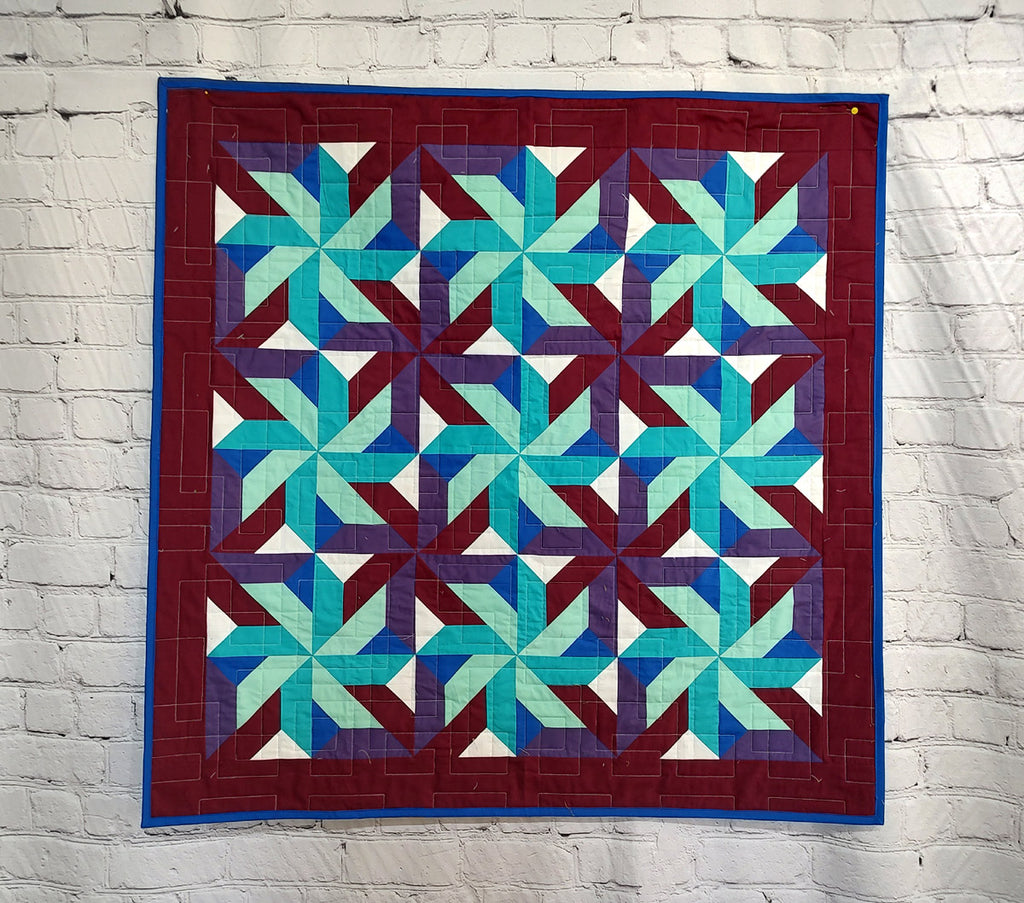 Whirling Star Solid colors purple and blue modern baby lap quilt