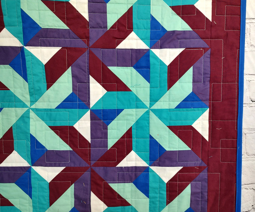 Whirling Star Solid colors purple and blue modern baby lap quilt