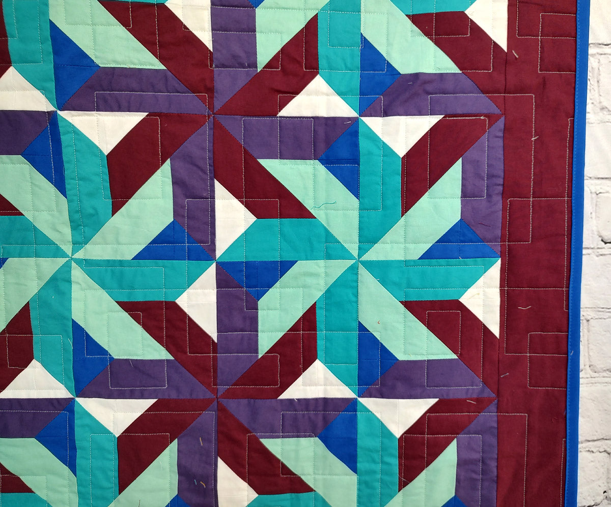 Whirling Star Solid colors purple and blue modern baby lap quilt